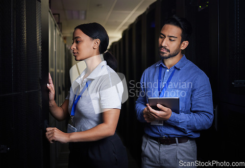 Image of Engineer, server room teamwork and woman opening panel for maintenance or repairs at night. Cybersecurity, programmers and female with man holding tablet for software or networking at data center.