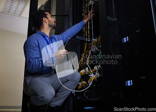 Image of Tablet, server room and engineer with connection cable for maintenance or software update at night. Cybersecurity wire, programmer and it man holding technology for database networking in data center