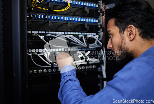 Image of Engineer, server room and man with cable connection for software update or maintenance at night. Information technology wire, cloud computing and male programmer check database network in data center