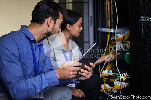 Image of Engineer teamwork, server room and tablet for connection cable, maintenance or software update at night. Cybersecurity wire, programmers or man and woman with technology for networking in data center