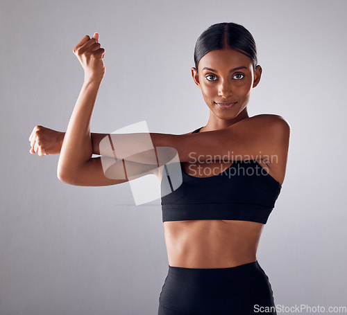 Image of Health, portrait and studio woman stretching for cardio fitness running, marathon training or body healthcare goals. Performance workout start, exercise or athlete warm up isolated on grey background