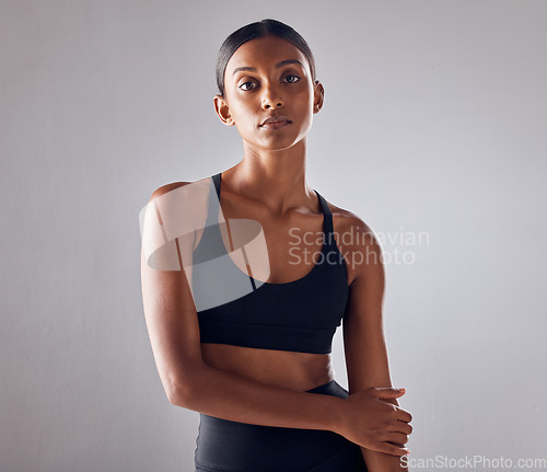 Image of Portrait, fitness and young woman isolated on studio background for health, wellness and training mockup. Confident indian person, athlete or model with sports fashion, workout and exercise for body