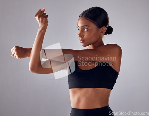 Image of Exercise, health and studio woman stretching for cardio fitness running, marathon training or body healthcare goals. Performance workout start, wellness or athlete warm up isolated on grey background