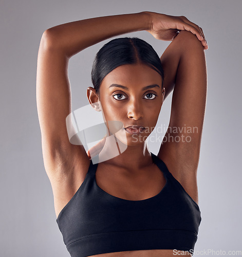 Image of Exercise, face portrait and woman stretching for cardio fitness running, marathon training or body healthcare goals. Performance workout, studio health or athlete warm up isolated on grey background