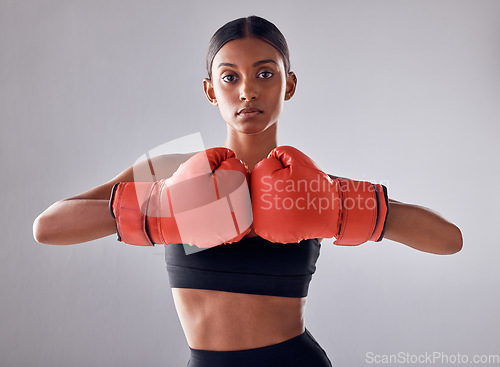 Image of Boxing, hand gloves and portrait of woman in studio for sports exercise, strong muscle or mma training. Indian female boxer, workout and fight for impact, energy and warrior power in battle challenge