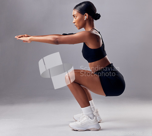 Image of Exercise, black woman and squat for training, workout and fitness for health, wellness and grey studio background. Female, lady and athlete bending, stretching and practice for endurance and energy