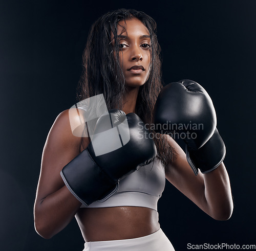 Image of Boxer, fight and portrait of woman on black background for sports, strong focus or mma training. Female boxing, workout or fist gloves of impact, energy and warrior power for studio fitness challenge