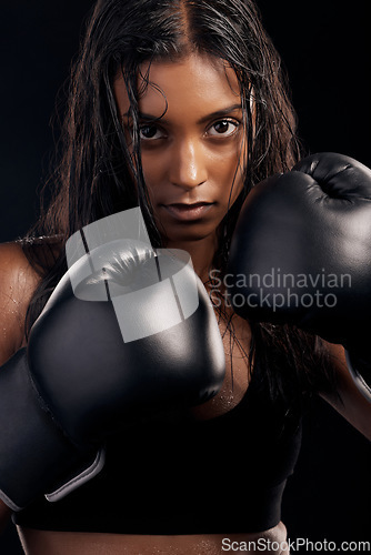 Image of Boxing, gloves and portrait of woman on black background for sports, strong focus or mma training. Female boxer, workout or fist fight of impact, energy and warrior power for studio fitness challenge