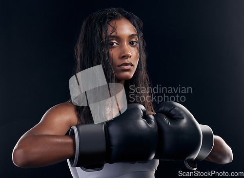 Image of Portrait, woman and boxer with fitness, serious and ready for match, confident and dark studio background. Face, female athlete and lady with gloves, training or endurance for energy, strong or power