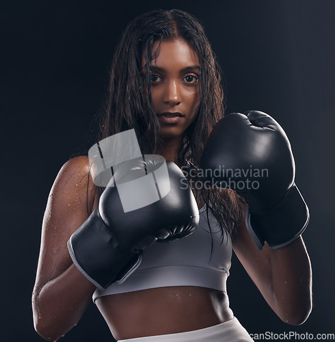 Image of Boxing champion, portrait and woman on black background for sports, strong focus and mma training. Female boxer, gloves and fist fight of impact, energy and warrior power for studio fitness challenge