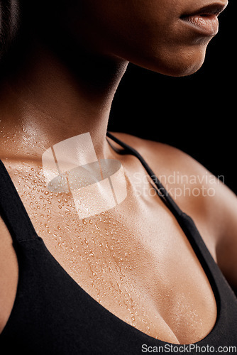 Image of Fitness, sweat and chest of a woman in a studio after an intense workout or sport training. Sports, health and healthy female athlete sweating after a health gym exercise by a black background.