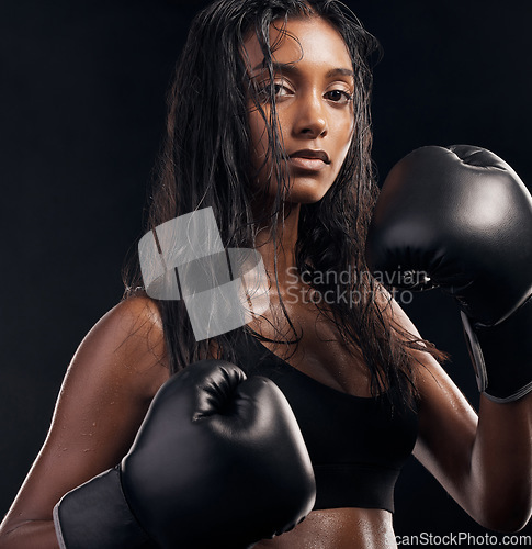 Image of Boxer, gloves and portrait of woman on black background for sports, strong focus or mma training. Female boxing, workout or fist fight of impact, energy and warrior power for studio fitness challenge