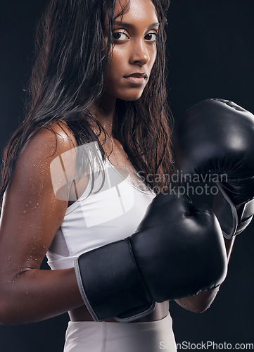 Image of Boxer champion, woman and portrait on black background for sports, strong focus or mma training. Female boxing, gloves and fist fight in studio, impact and warrior energy for power of fitness workout