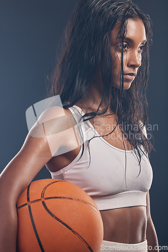 Image of Basketball player, sports workout and studio woman for wellness challenge, practice game or fitness competition. Performance training, health exercise and athlete model isolated on dark background