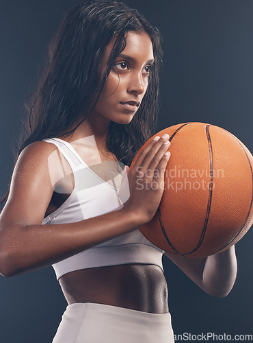 Image of Basketball player, sports exercise and studio woman for wellness challenge, practice game or fitness competition. Health performance, training workout and athlete model isolated on dark background