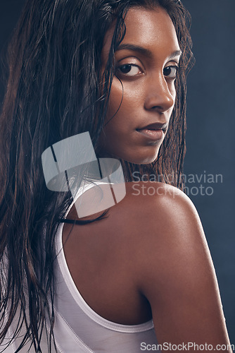 Image of Health, sweat and portrait of a woman for fitness isolated on a dark background in a studio. Gym, sports and face of an Indian athlete with commitment to cardio training, exercise and workout