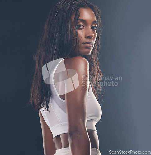 Image of Wellness, fitness and portrait of a black woman in studio after a exercise or sport training. Health, sports and female athlete with strong, motivation and workout mindset isolated by gray background