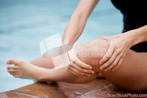 Image of Hands, knee injury and swimming pool with a woman holding her joint in pain after a sports workout. Fitness, water and anatomy with a female swimmer suffering from an injured leg during exercise