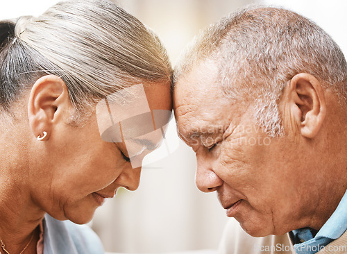 Image of Face, love and trust with a senior couple in their home, touching heads in support or solidarity together. Relax, peace or romance with a mature man and woman bonding in their house during retirement