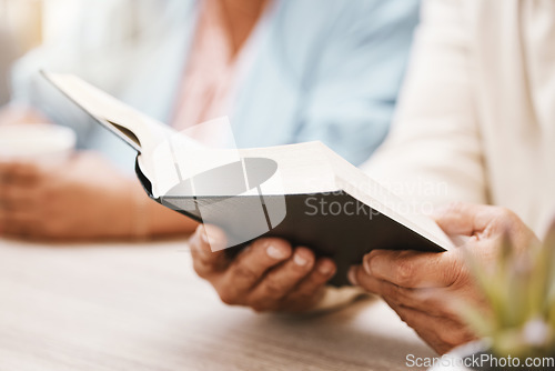 Image of Book, faith and hands of couple with bible for spiritual studying or reading in home. Religion, worship and man and woman with holy and religious text for learning, education and worshipping God.