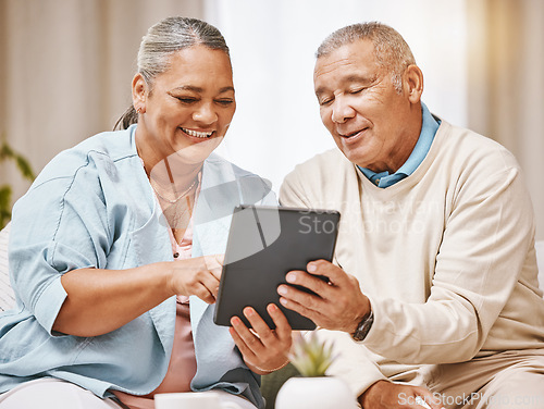 Image of Love, relax and senior couple with tablet in home for social media, web browsing or internet scrolling. Technology, retirement and elderly man and woman with digital touchscreen for streaming movie.