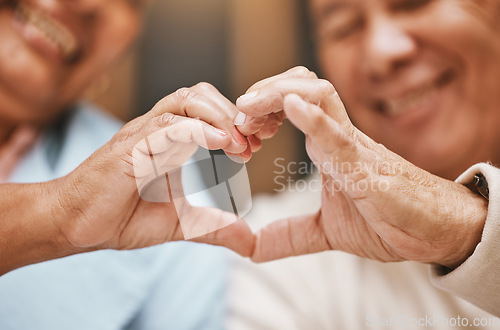 Image of Love, heart hands or happy old couple with support, trust or hope in a marriage commitment at home. Romance, valentines day or senior man smiles with an elderly woman relaxing on anniversary