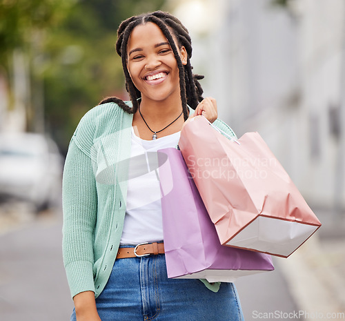 Image of Fashion, portrait or happy black woman shopping with a smile walking on city street in retail therapy. Freedom, relax or African gen z girl with clothes, gift or products on discounted sales offer