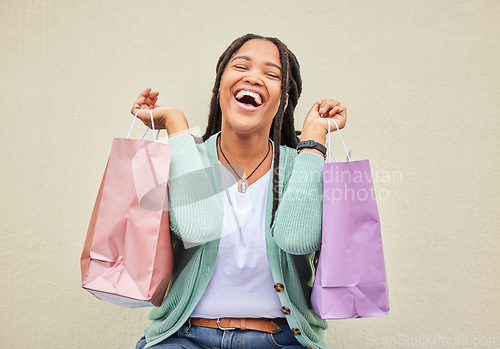 Image of Fashion, funny or happy black woman with shopping bag, gift or smile in retail therapy with wall mockup. Freedom, relax or excited customer laughing with clothes or products on discounted sales offer
