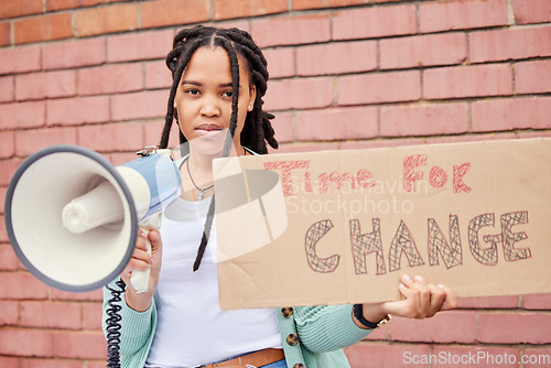 Image of Poster, portrait and woman on megaphone for change, protest or human rights on brick wall background. Banner, speaker and face of girl for announcement of global, transformation or freedom mission