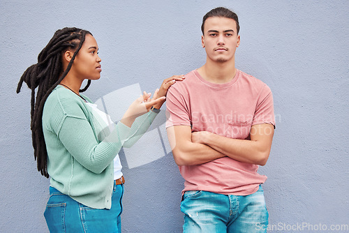 Image of Interracial couple, wall background and argument in metro with black woman, question and conversation. Young gen z man, partner and conflict in city with relationship, fight and angry arms crossed