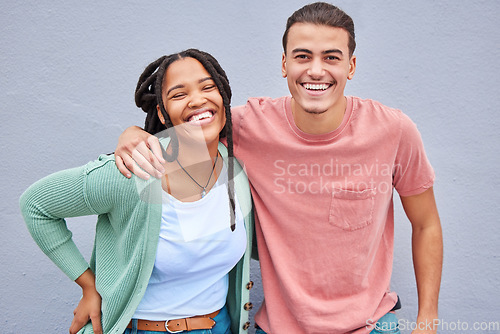 Image of Love, romance and portrait of a happy couple by a wall in the city while on a vacation or weekend trip. Happiness, smile and interracial man and woman embracing while walking in town on a holiday.
