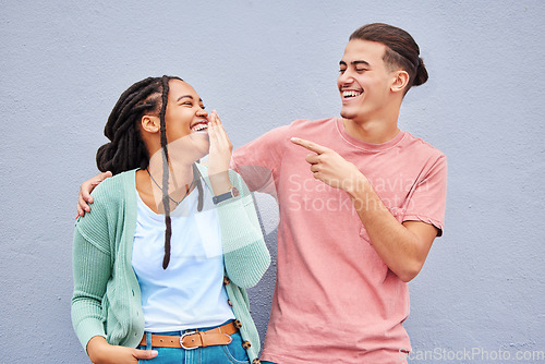 Image of Joking, laugh and happy with a couple on a gray background, outdoor for fun or freedom together. Laughing, humor or smile with a young man and woman enjoying laughter while bonding against a wall