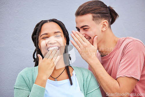 Image of Laugh, secret and boyfriend whisper to his girlfriend a funny story, joke or information by a wall in city. Comic, happy and man talking in woman ear for gossip in town on a holiday or weekend trip.