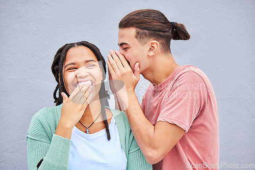 Image of Love, secret and man whisper to his girlfriend a funny story, joke or information by a wall in city. Comic, laughing and guy talking in woman ear for gossip while in town on holiday or weekend trip.