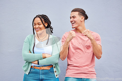 Image of Happy, laughing and interracial couple being funny together isolated on a background. Comic, smile and dancing man with a black woman with arms crossed and pride after a fight on a wall backdrop