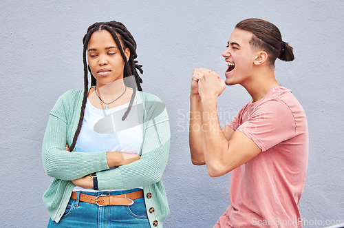 Image of Winner, competition and celebration with a man cheering after winning a bet against his loser girlfriend on gray background. Success, wow or victory with a boyfriend celebrating a win against a woman