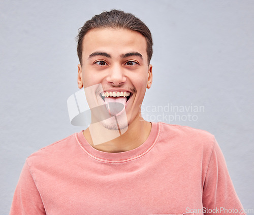 Image of Man, tongue or funny face on isolated background in silly, goofy or comedy on grey mockup, wall or mock up backdrop. Comic, emoji or happy student in fashion clothes, style trend or facial expression