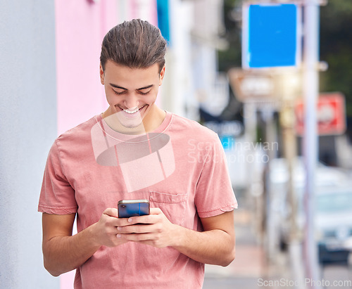 Image of Man, cellphone and typing in city for social media, technology and iot networking. Happy young guy walking in urban street with smartphone, connection and reading notification of online internet post