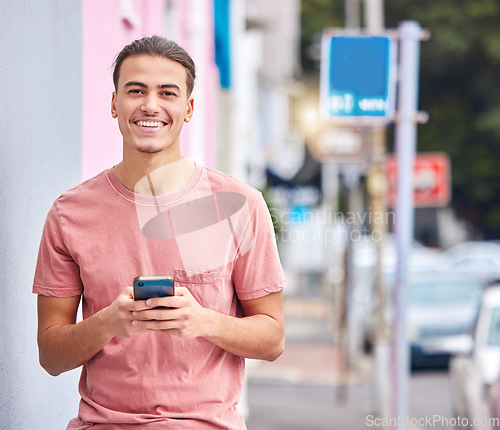 Image of Man, portrait or phone text on city street, road or urban location on social media app, dating website or internet networking. Smile, happy or student model on mobile communication technology or gps