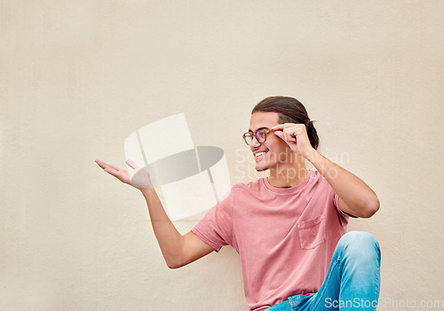 Image of Mockup, hands and happy man pointing to space for advertising, empty and grey wall background. Hand, gesture and guy relax, content and smile in studio for product placement, marketing and copy space