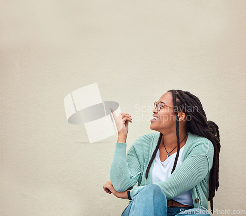 Image of Black woman, happy and hands pointing to mockup, advertising or empty background, laugh and excited. Hand gesture, smile and girl relax in studio while showing wall copy space for isolated marketing