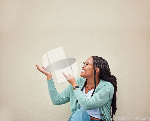 Image of Happy, black woman and hands pointing to mockup, advertising or empty background, laugh and excited. Hand gesture, smile and girl relax in studio while showing wall copy space for isolated marketing