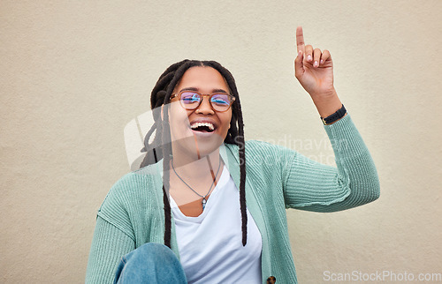 Image of Up sign, portrait and black woman pointing with mockup in studio for advertising, space and wall background. Face, direction and girl happy, smile and excited for product placement on copy space