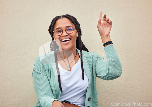 Image of Hand, sign and woman with mockup in studio for advertising, questions and space on wall background. Face, direction and hand gesture by happy, smile and cheerful girl showing product placement offer