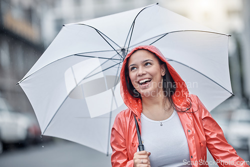 Image of Outdoor, umbrella and black woman with smile, city and freedom on break, joyful and cheerful. Jamaican, female and lady with cover from rain, town and urban with happiness, comfortable and travel