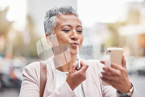 Image of Woman, phone and lipstick in city for makeup, happy or cosmetics for financial service career. Accountant, cosmetic and face beauty by blurred background in metro, summer and smartphone for aesthetic