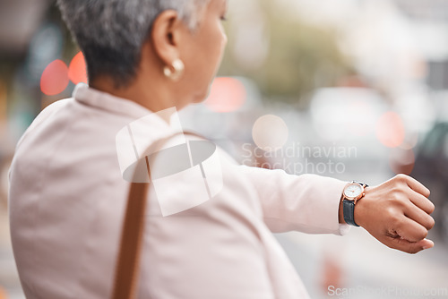 Image of Watch, senior woman and check time for appointment, deadline and schedule while travelling. Female employee, manager and mature lady with wrist watch, outdoor and commute to work, late and waiting