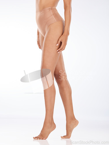 Image of Legs, feet and skin, black woman with epilation and laser hair removal with waxing on studio background. Cosmetics, beauty and glow with skincare, pedicure and spa treatment with mockup space