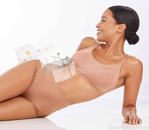 Image of Body, skincare flowers and black woman isolated on a white background beauty, product or cosmetics mockup. Studio model or person relax on floor with floral, dermatology and luxury spa in underwear