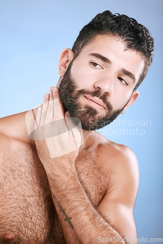 Image of Idea, skin and grooming with a man model in studio on a blue background for natural wellness or beauty. Face, beard and skincare with a handsome young male thinking about cosmetics or treatment